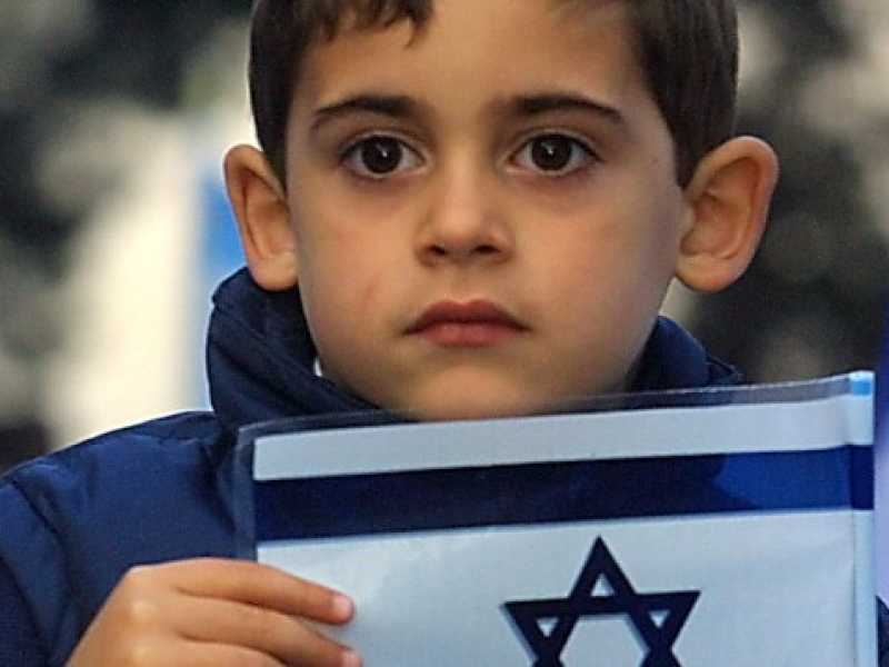 Un bambino con la bandiera di Israele (foto Roberto Monaldo/LaPresse) 
