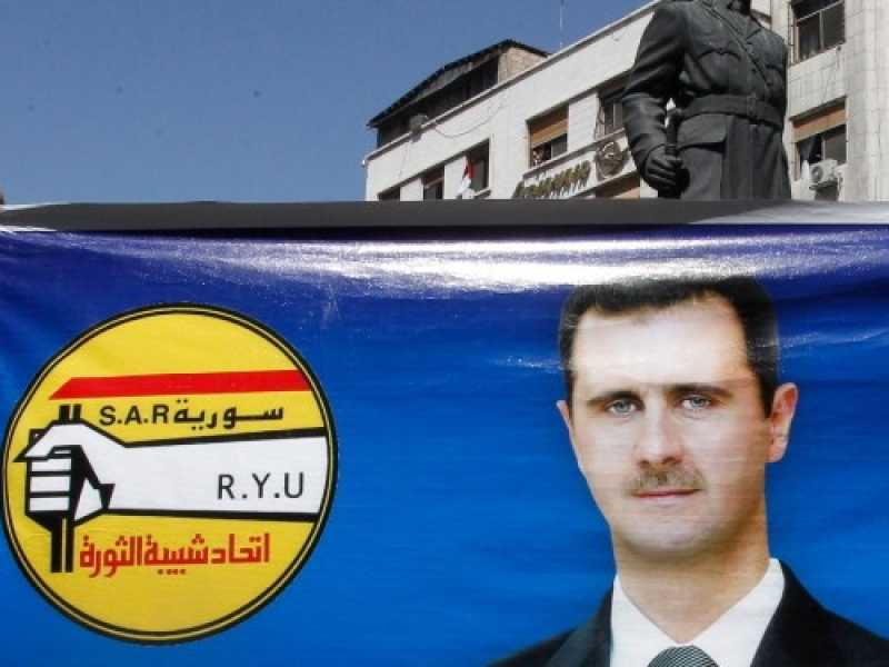 Sostenitori del presidente siriano Bashar el Assad, figlio del presidente precedente Hafez al Assad, prima delle &ldquo;elezioni&rdquo; del 2014. Il candidato del partito unico Baath vinse con il 92 per cento