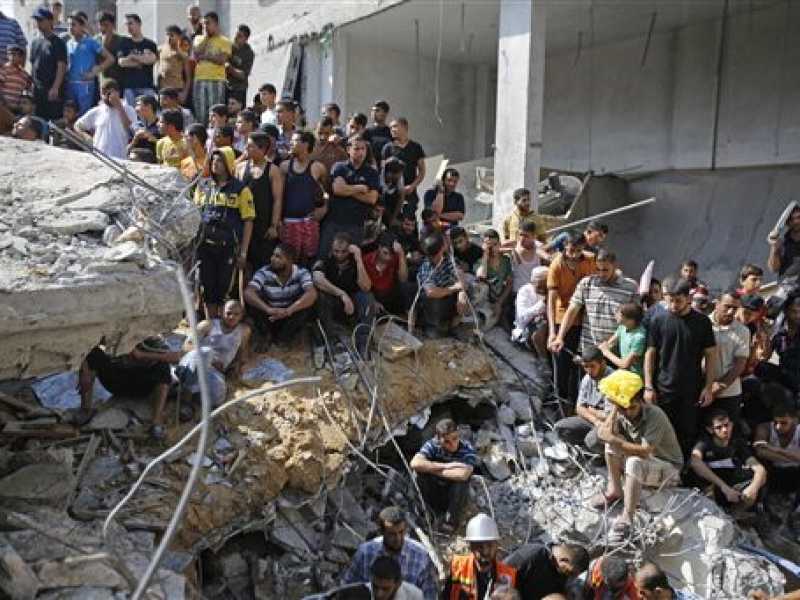 Palestinesi sulle macerie della moschea di al Qassam, vicino al campo profughi di Nuseirat, nella Striscia di Gaza (Foto Ap) 
