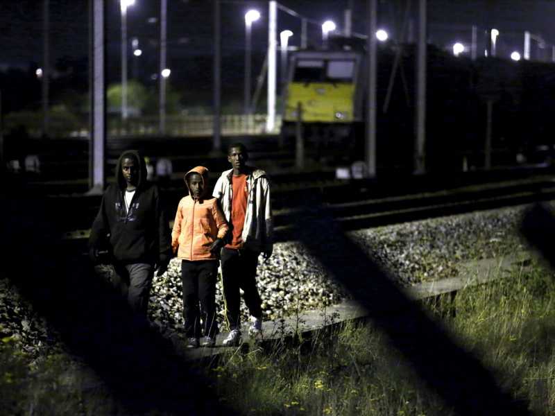 Migranti cercano di accedere al tunnel di Frethun, vicino Calais, per entrare nel Regno Unito (foto LaPresse)