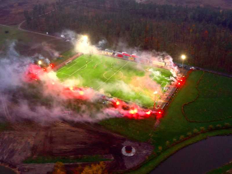 Lo stadio da 200 posti in mezzo ai campi in cui si sono svolte le battaglie dello scorso anno, con i fumogeni colorati lungo il campo&nbsp;<br />