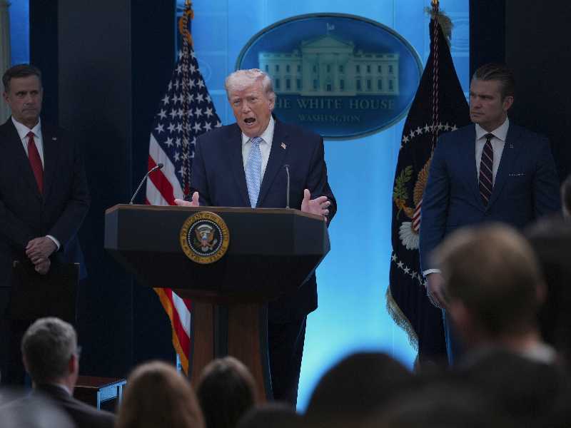President Donald Trump, center, with CIA Director John Ratcliffe, left, Defense Secretary Pete Hegseth, right, speaks with reporters in the James Brady Press Briefing Room at the White House, Monday, April 6, 2026, in Washington. (AP Photo/Julia Demaree Nikhinson)