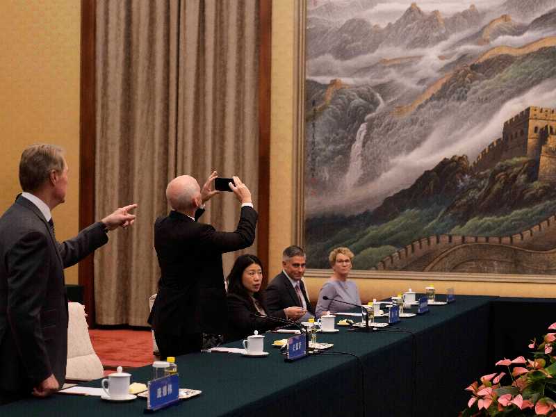 Il deputato Usa Adam Smith fotografa un dipinto della Grande Muraglia prima di un incontro con il vicepremier cinese He Lifeng a Pechino, il 22 settembre 2025